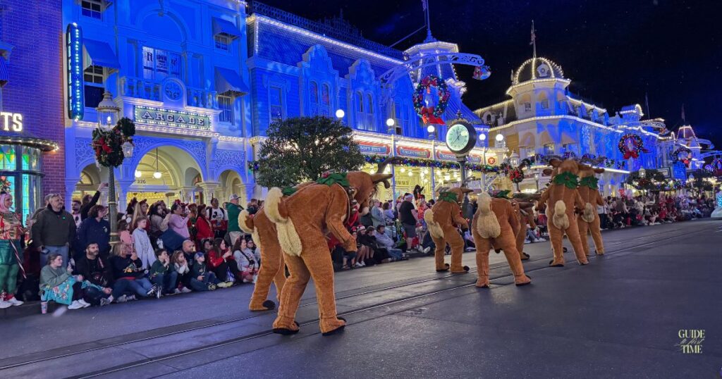Reindeer dancers in Mickey's Once Upon a Christmastime Parade, with crowds lining Main Street