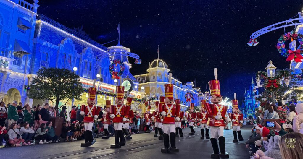 Toy soldiers marching in Mickey's Once Upon a Christmastime Parade on Main Street, U.S.A. at night